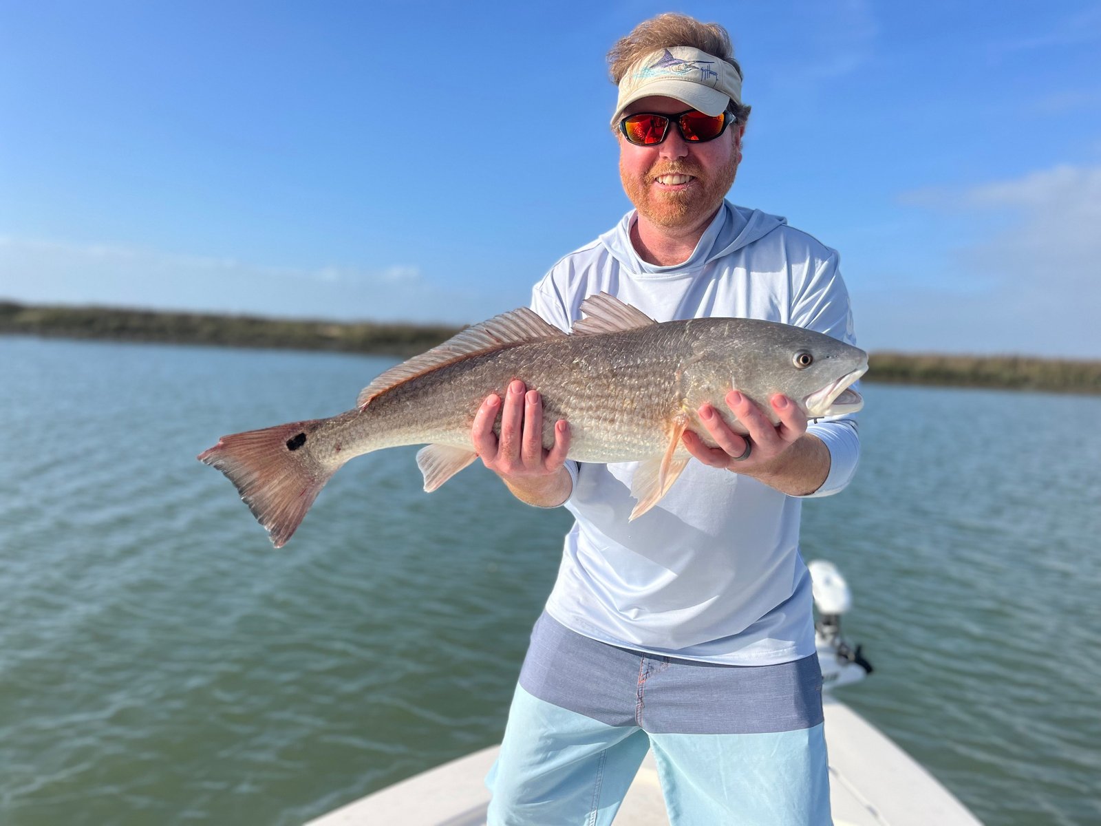 Man holding a redfish during a 4-hour inshore fishing trip with Marsh View Charters in Charleston, SC