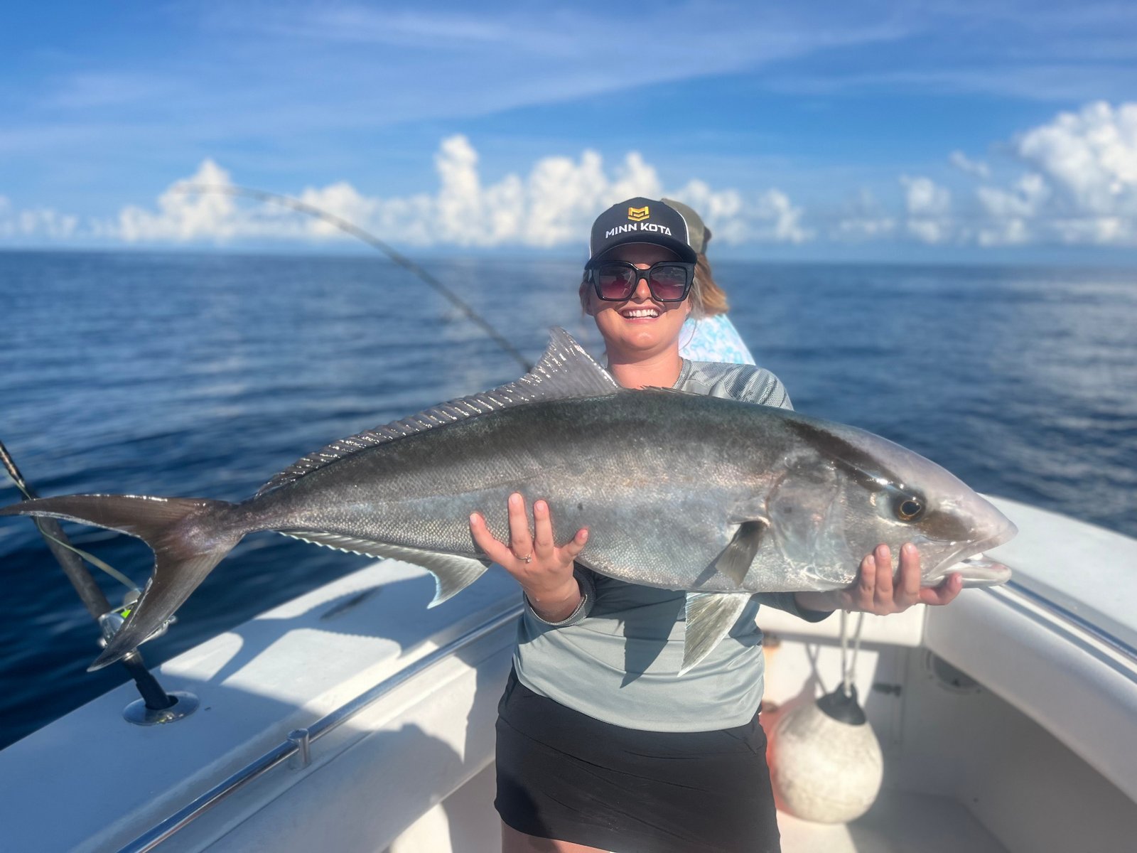 Woman holding a large amberjack on an offshore charter with Marsh View Charters in Charleston, SC