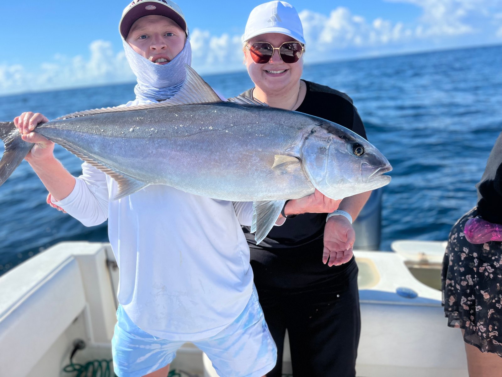 Two happy anglers showing off a hefty amberjack from a Charleston offshore trip